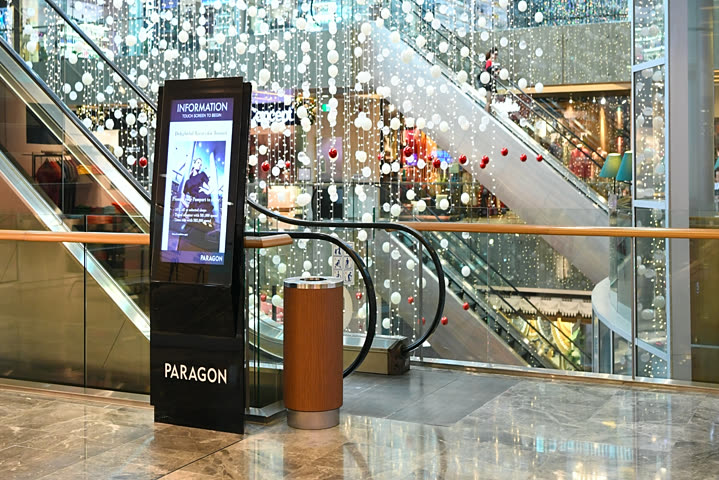 Abuzz interactive directory kiosk on the concourse of a premium shopping mall