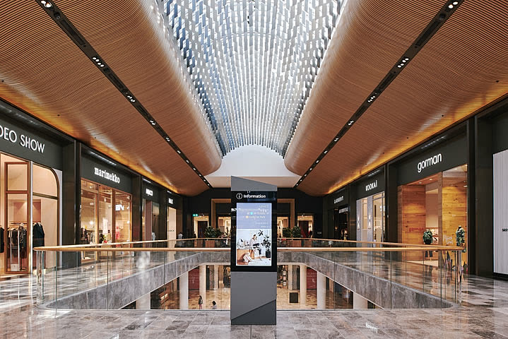 Abuzz wayfinding totem in a luxury mall atrium