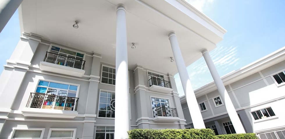 Exterior of the Australian International School Bangkok campus with white columns