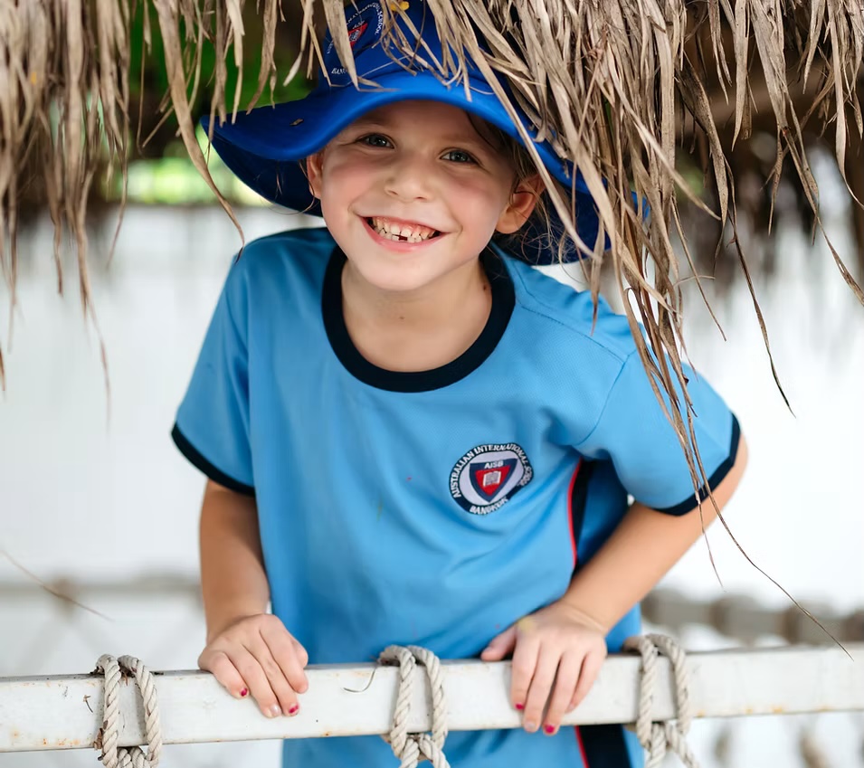 Smiling AISB primary student in school sports shirt