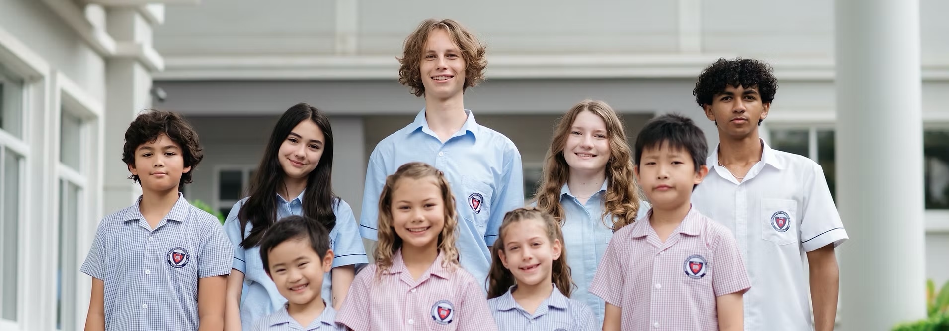 Group of Australian International School Bangkok students of different ages standing together outside the campus