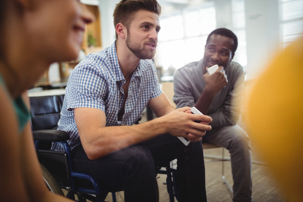 A counsellor listening attentively during a group therapy session