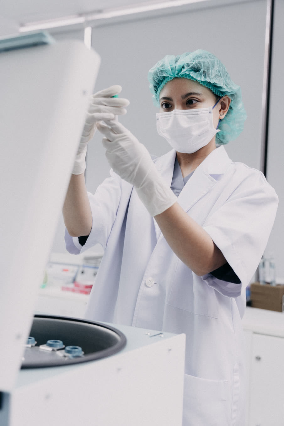 First Fertility embryologist preparing samples beside the centrifuge