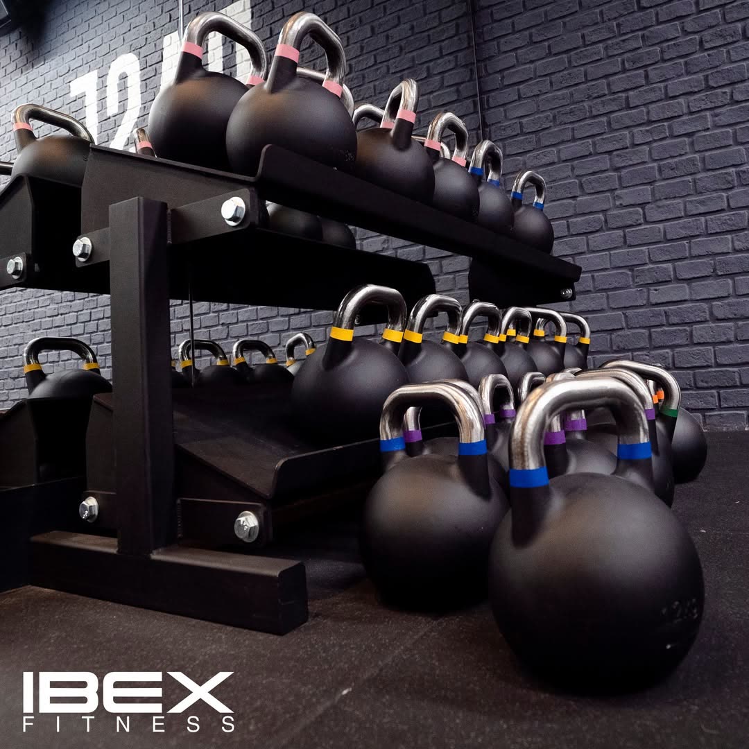 IBEX competition kettlebells on a storage rack