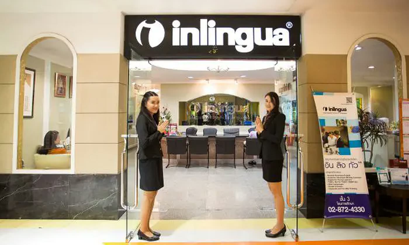 Staff welcoming students at the entrance of an inlingua language school branch