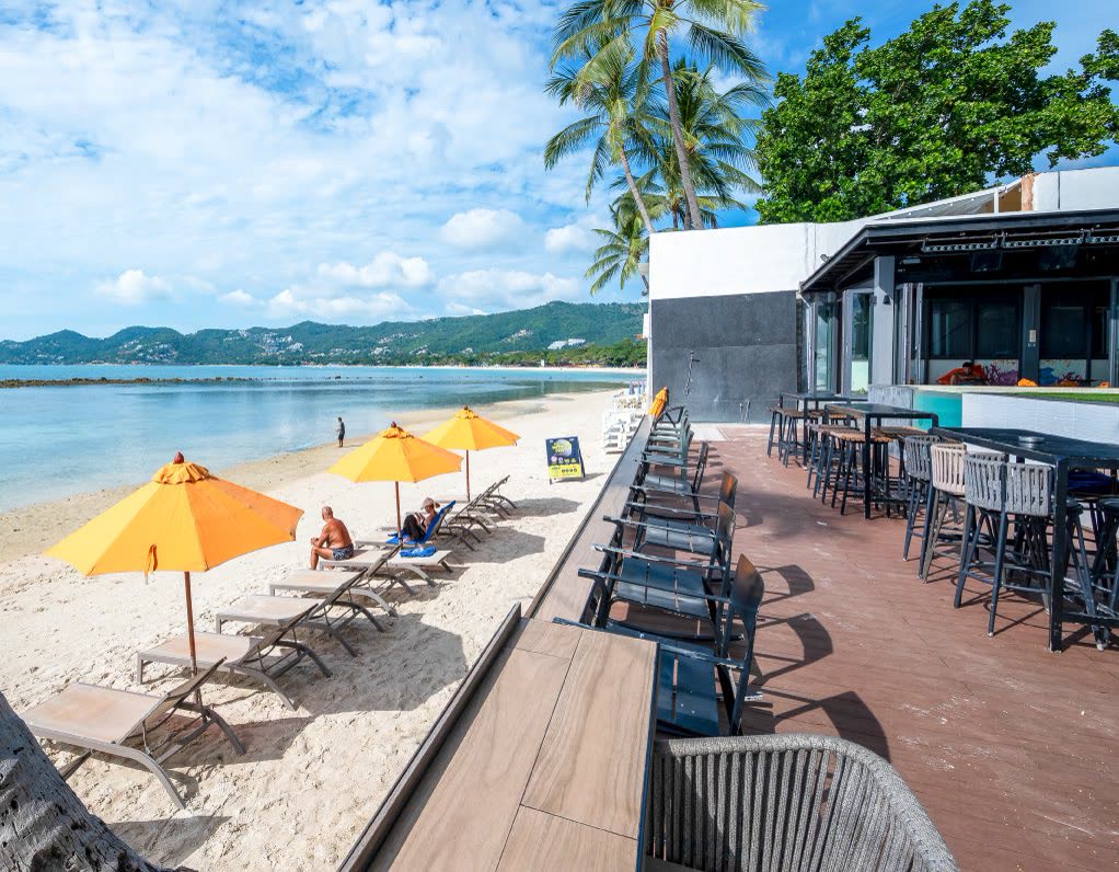 Beachfront deck with orange umbrellas at Lub d Koh Samui Chaweng Beach