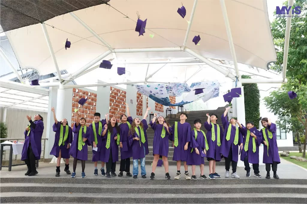 Magic Years students celebrating graduation by throwing their caps