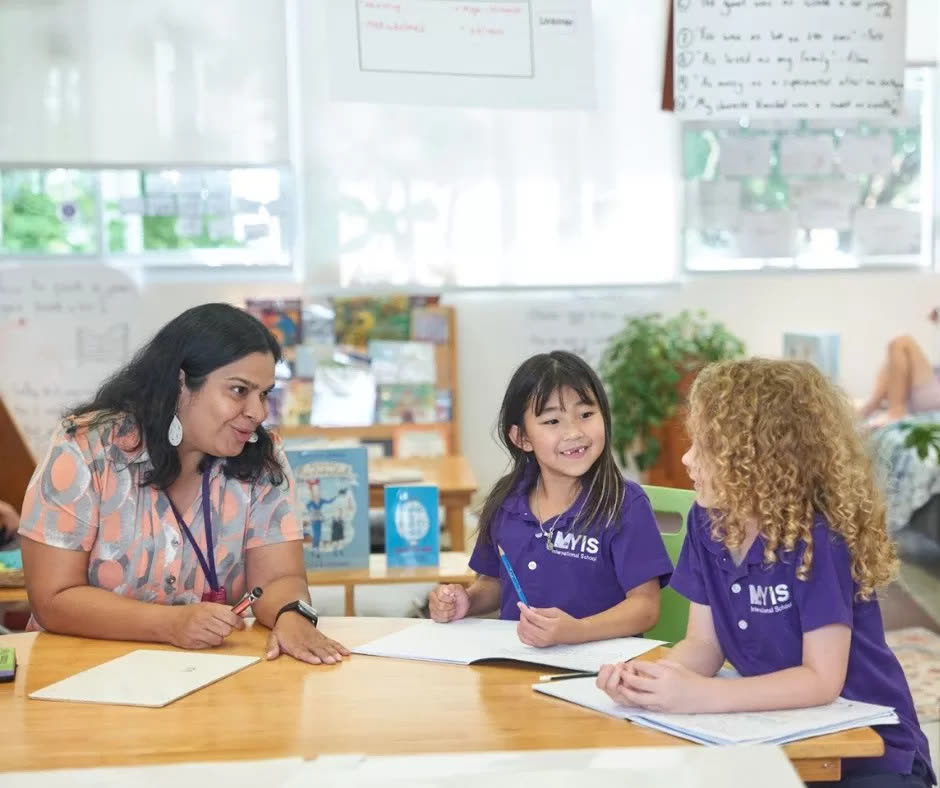 Magic Years students working with their teacher in class