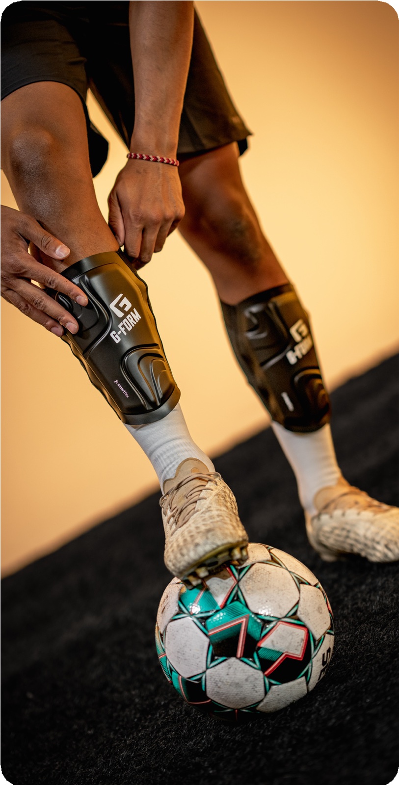An athlete with a prosthetic leg balancing a football