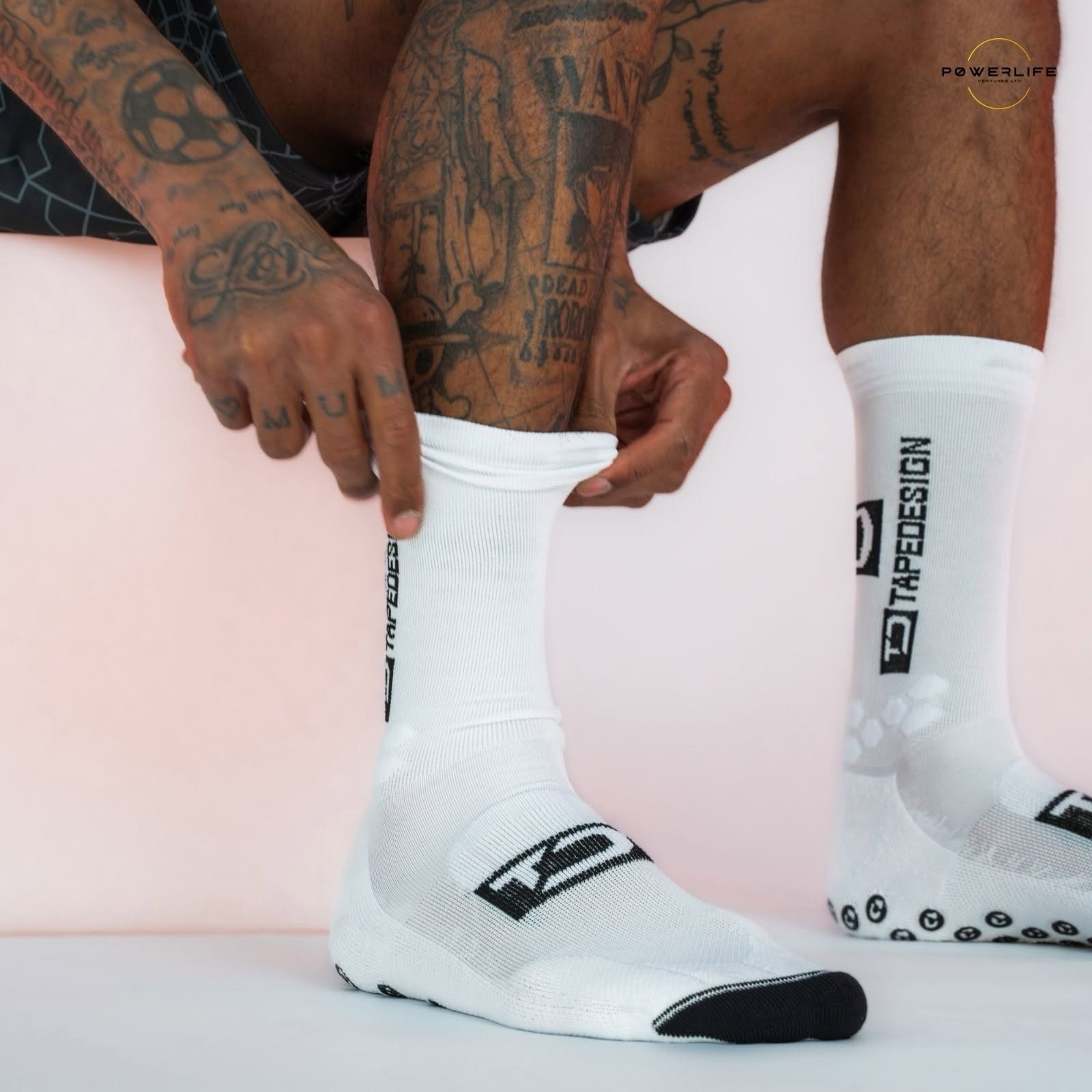 An athlete putting on Powerlife grip performance socks