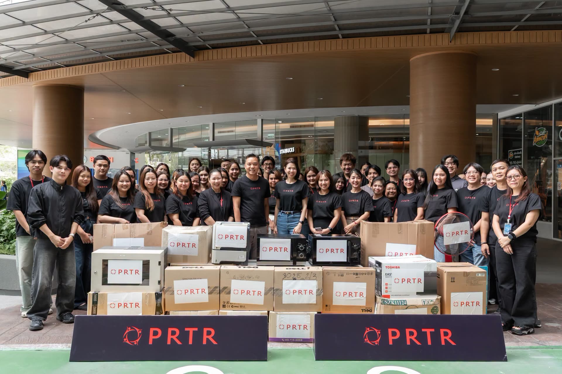 The PRTR team gathered with branded boxes at a company donation drive