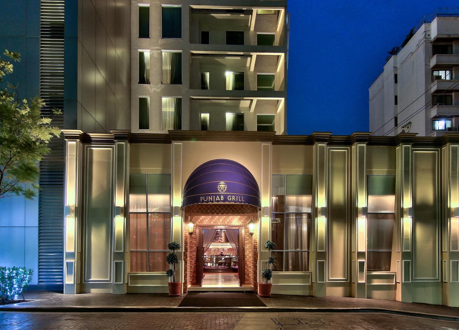 Illuminated entrance of Punjab Grill restaurant in Bangkok at night