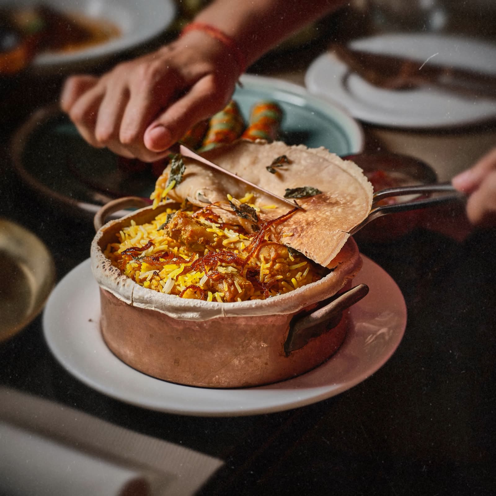 Punjab Grill signature dum biryani served in a copper pot