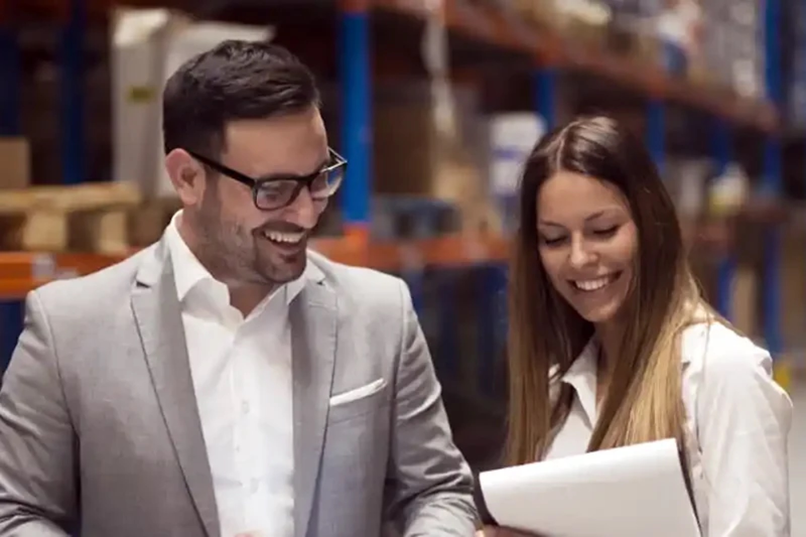 Source One staff reviewing products in a warehouse