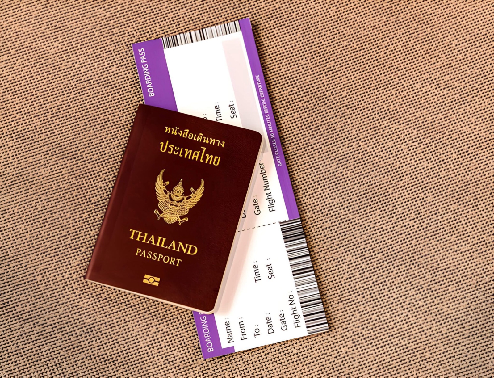 A Thailand passport with a boarding pass