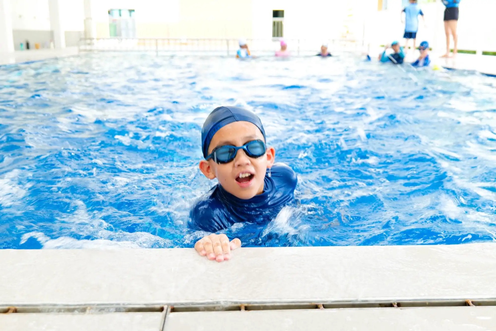 A TSI International School student swimming during a lesson