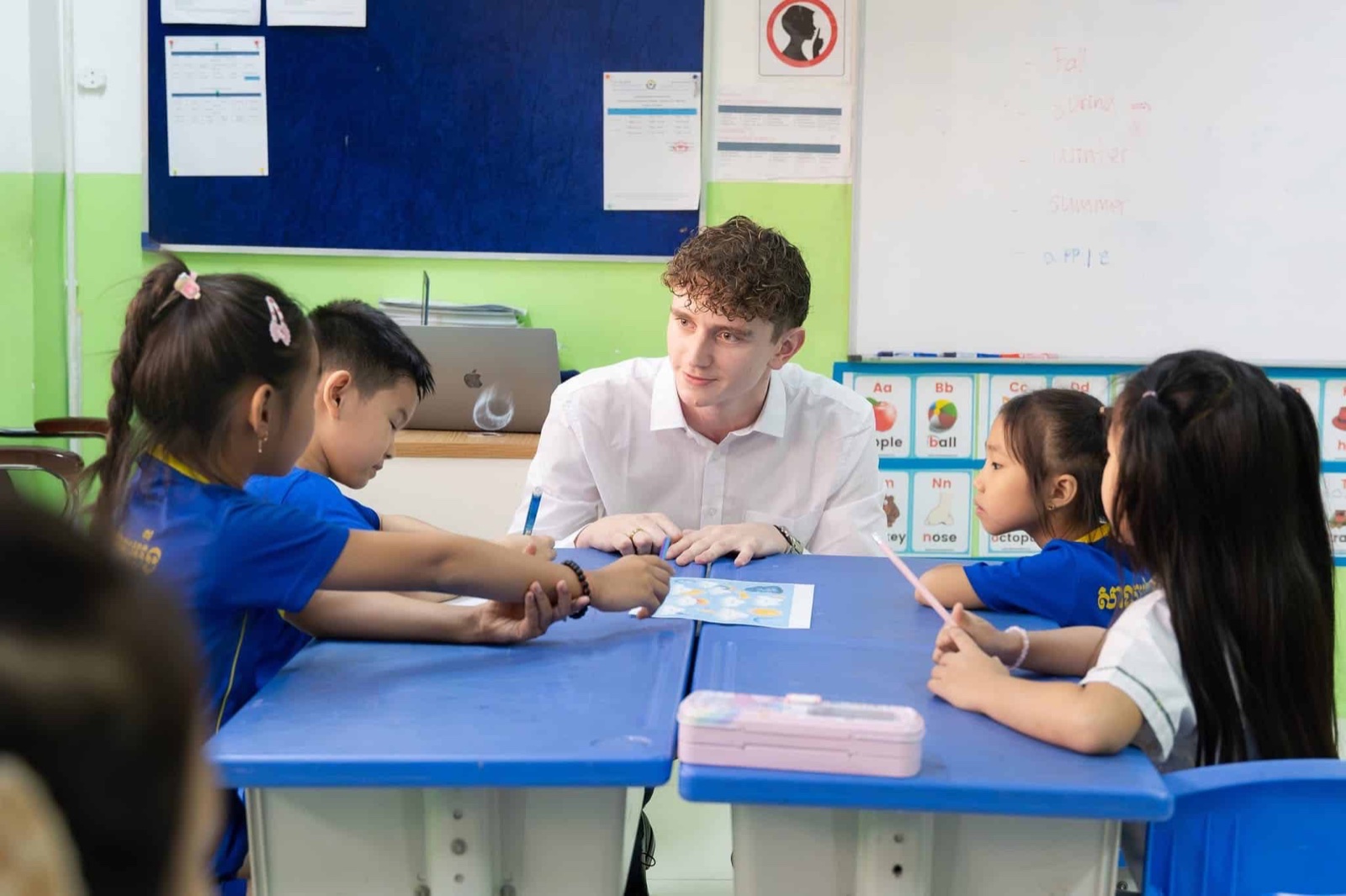 An Xplore Asia teacher leading a classroom of students in Asia