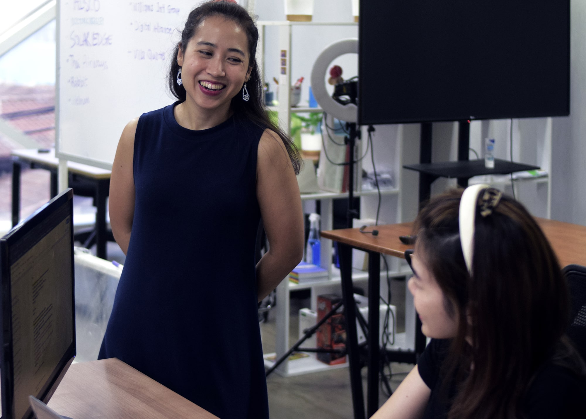 Phoenix Media team member smiling during a discussion at the office
